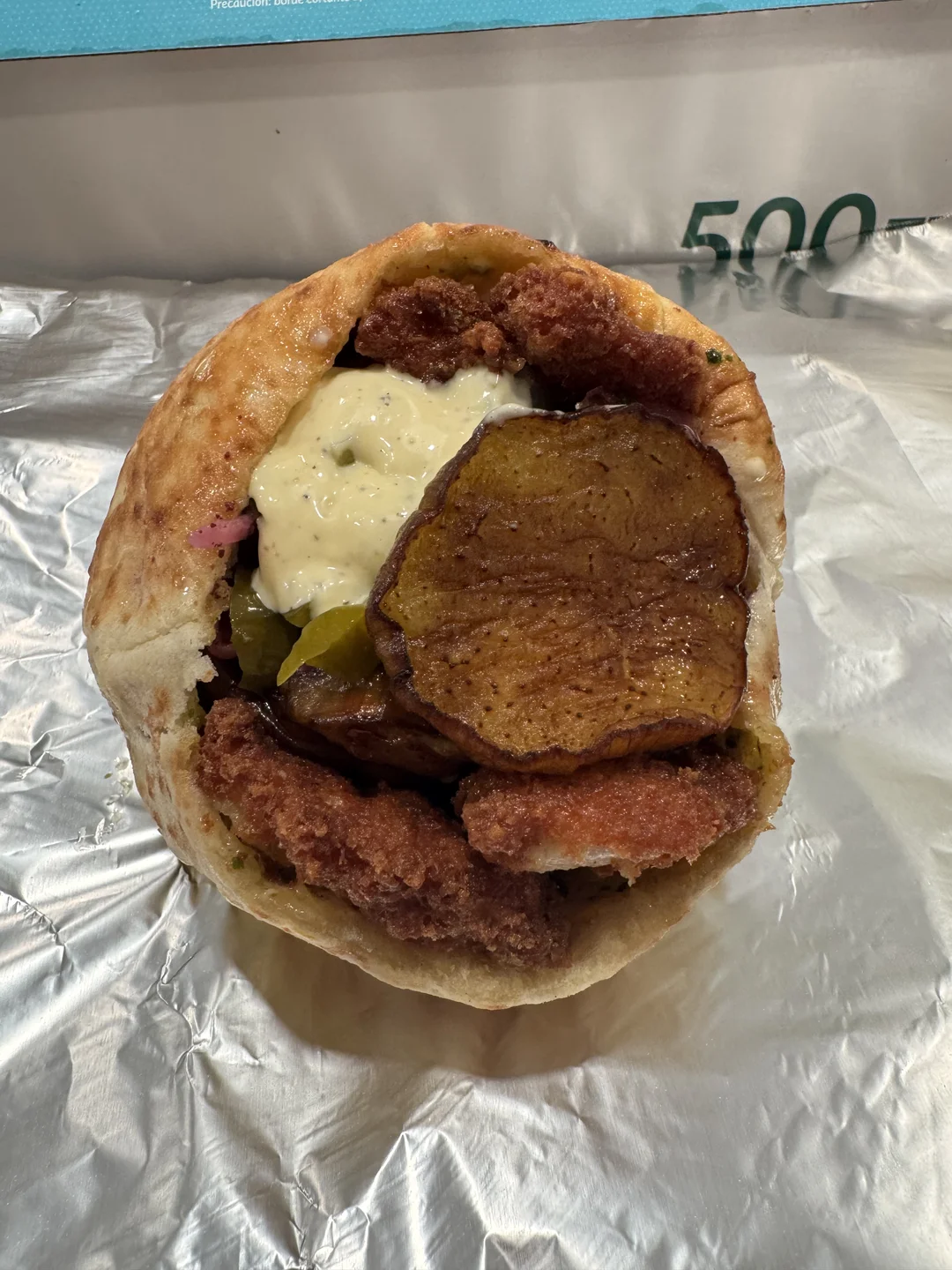 Stuffed pita with falafel, fried eggplant, pickles and garlic sauce