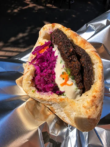 Stuffed pita with Moroccan kabob, roasted eggplant, tomato and tahini